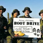 Capt Fahim Awan, LS Luis Lemus, MCpl Brad Axworthy, and MS Sarah Zimmer hold up boots and a sign, ready for their fundraising drive.
