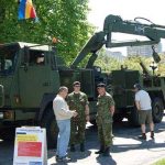 MCpl Dan Marcil and Cpl Alistair Stewart, members of 11 Service Company, answer questions from the public after the Victoria Day Parade.
