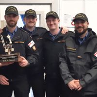 The winning team of this month’s Seamanship Olympics, the Temporary Holding Platoon. They are pictured here with the Seamanship Olympics Trophy presented by LCdr Chris Maier.