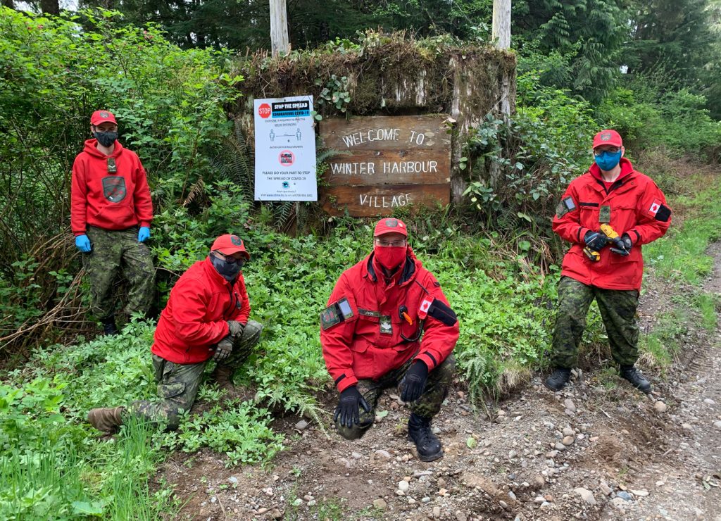 Members of the Port Hardy Canadian Ranger Patrol install signage in Winter Harbour on May 9.