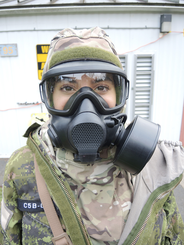 Trial participant Corporal Quian Meftah of 35 Combat Engineer Regiment displays her C5B gas mask outside the gas hut, Nov. 29, 2023, at CFB Esquimalt's Damage Control Training Facility Galiano. Photo: Peter Mallett/Lookout