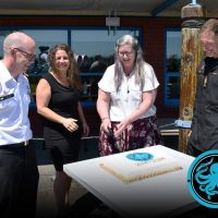 Commander Darren Sleen (left) and Chief Petty Officer 1st Class André Aubry (right) invite Josée Lafontaine and Laura Brackenbury to cut the cake.