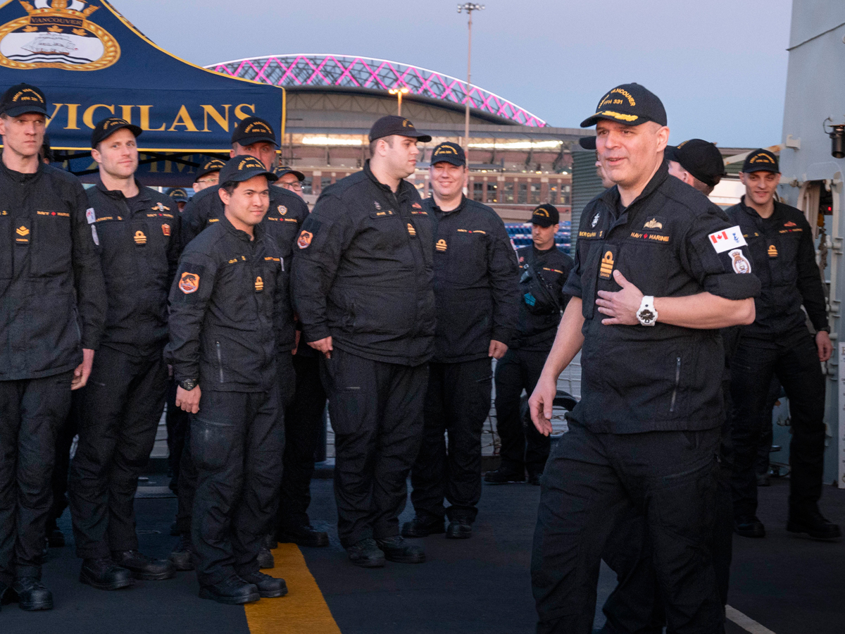 embers come to attention as Commander Tyson Bergmann, Commanding Officer of HMCS Vancouver, walks on deck to address the crew. Photo: Captain Pedram Mohyeddin