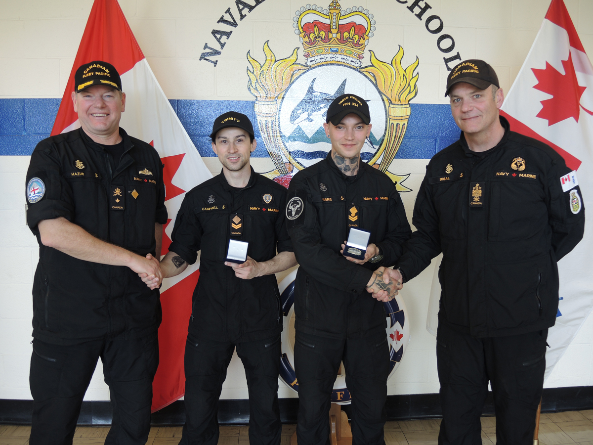Commodore David Mazur, Commander Canadian Fleet Pacific, and Chief Petty Officer 1st Class David Bisal, Fleet Chief, present Sailor 1st Class Nicholas Campbell and Master Sailor Tristan Harris with their Sailor of the Quarter certificates in a May 16 ceremony at Naval Fleet School (Pacific). Photos: Peter Mallett/Lookout Newspaper
