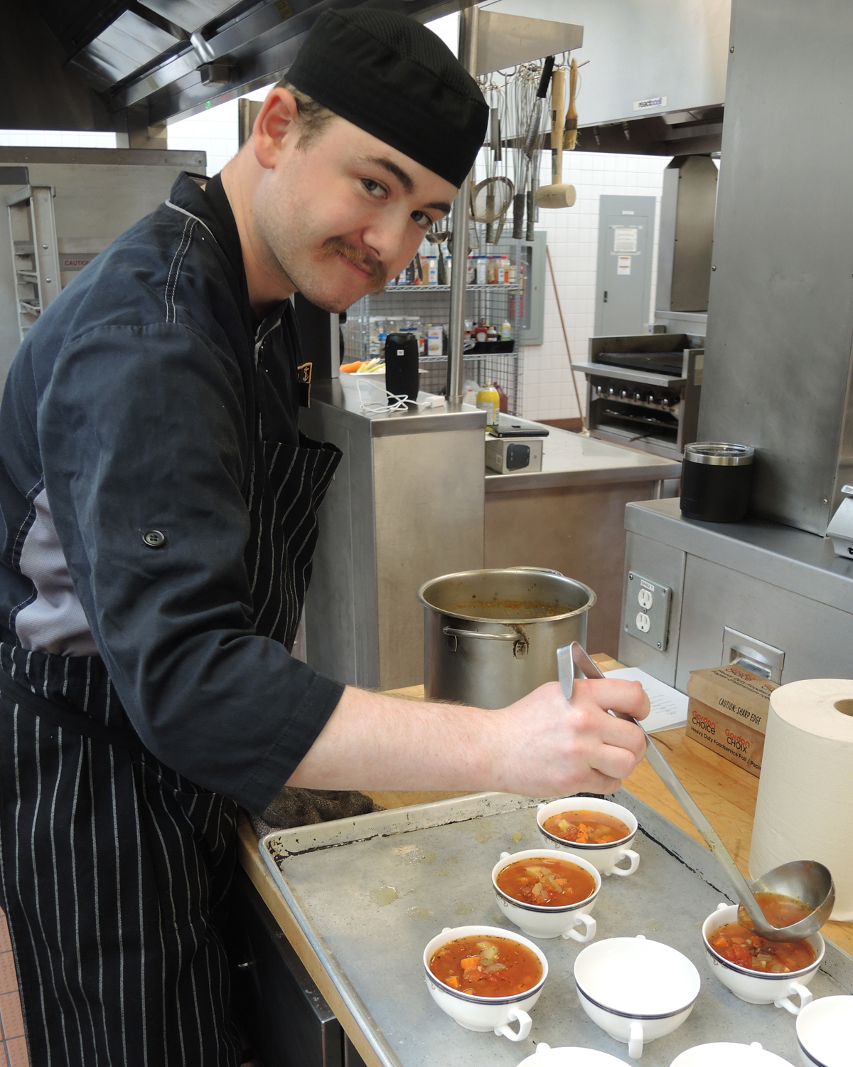 Sailor 2nd Class Trey Pennington, military cook-in-training, prepares dishes for his Confirmation Dinner.