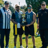 The Commissioner of the Canadian Football League Randy Ambrosie and Commodore of Canadian Fleet Pacific David Mazur present the winning team with the Commodore’s Cup during a flag football game held at Canadian Forces Base Esquimalt on Aug. 29.