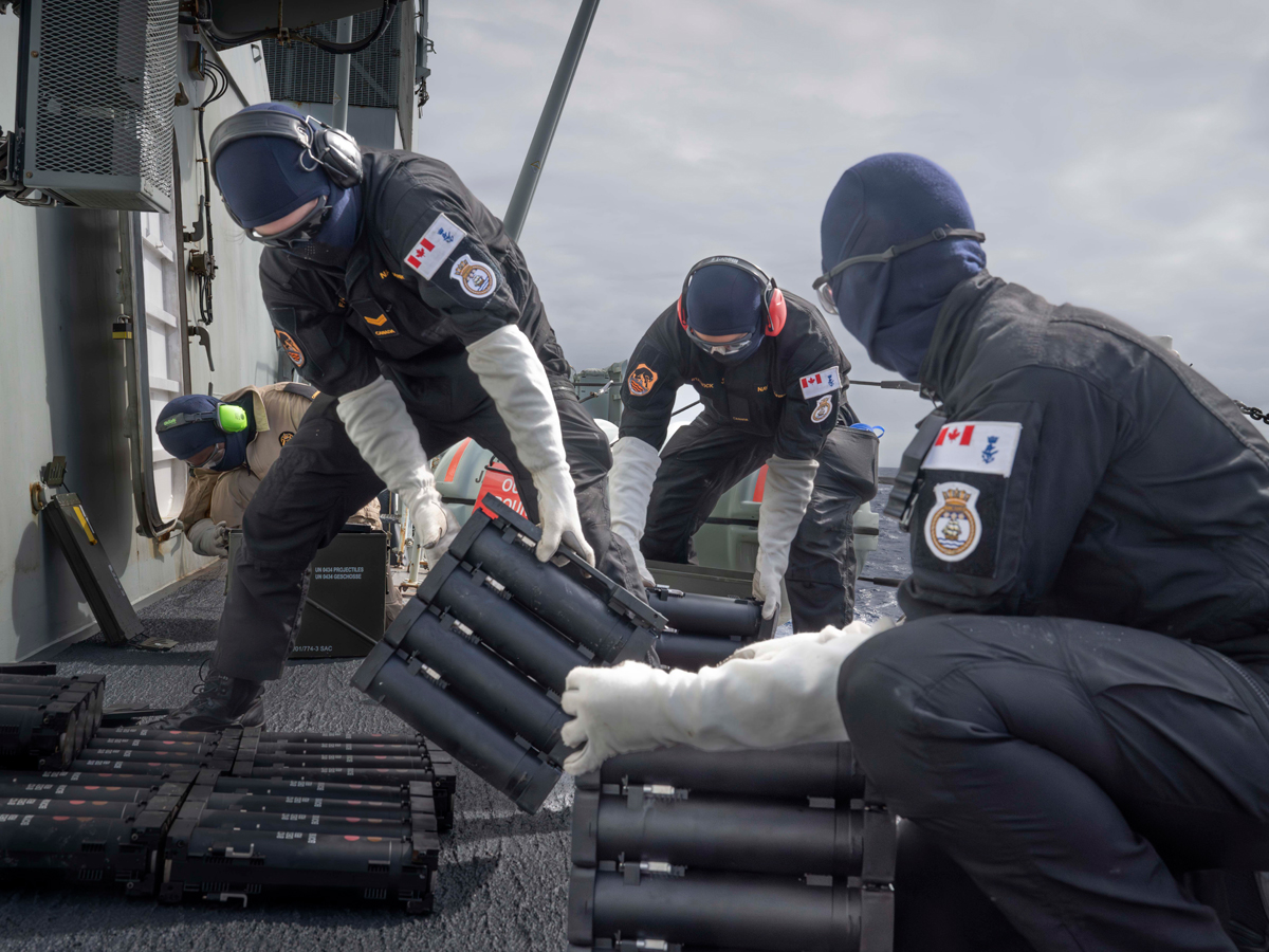 
Sailor 1st Class Dean Fisher (Left), Sailor 3rd Class Ryan Stalwick and a Royal Canadian Navy member aboard HMCS Vancouver prepare to reload the multi-ammunition soft-kill system launcher (MASS) during the Technical Cooperation Program Anti-Ship Threat Project Arrangement (TAPA) 2024 while at sea. TAPA is performed every two years, which allows for the testing and training of electronic warfare technology and tactics. Photos: Aviator Conor R.G. Munn, Canadian Armed Forces Imagery Technician.