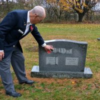 Hong Kong Veterans Commemorative Association volunteer Derrill Henderson points to the “HK” marker being added to gravestones across Canada, including that of John Levitt, a member of 1st Battalion, The Royal Rifles of Canada Canadian Active Service Force (CASF); in Trenholm, Que.