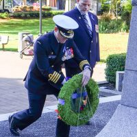 Caption: Captain (Navy) Kevin Whiteside, CFB Esquimalt Base Commander lays a wreath at Memorial Park in Esquimalt in honour of those who died during the HMCS Kootenay explosion, accompanied by CPO1 (ret'd) Al Darraugh, who was onboard that fateful day.