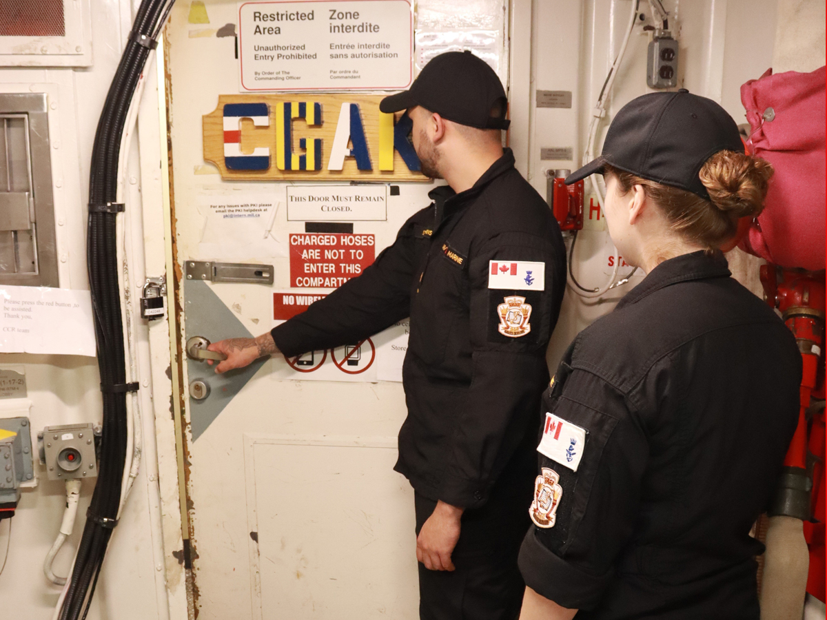 S1 Hannibal Stephenson and S3 Erica Jackson head into the Communications Control Room during an RQS2 course held at NFS(A), CFB Halifax this summer. Photo by MS Danny Laplante, Naval Fleet School (Atlantic).