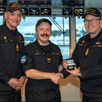 S1 Jacob Barrett is presented with the Sailor of the Quarter coin by Commander Sam Patchell, Deputy Commander of CANFLTPAC and CPO1 David Bisal, Fleet Chief on Sept. 16.