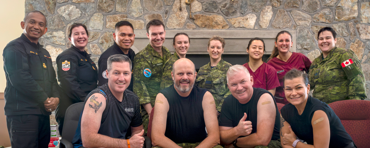 Group Photo of Rear-Admiral Christopher Robinson and Captain (Navy) Kevin Whiteside with the Vaccination Clinic staff at Wardroom, CFB Esquimalt on Oct. 22.
