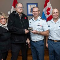 Mr. Jay Hammond recieves a set of wings created using the aluminum of his uncle's recovered Halifax bomber during a Commendation Presentation at 443 Maritime Helicopter Squadron on Oct. 18. Photo: Sailor 3rd Class Jordan Schilstra, MARPAC Imaging Services