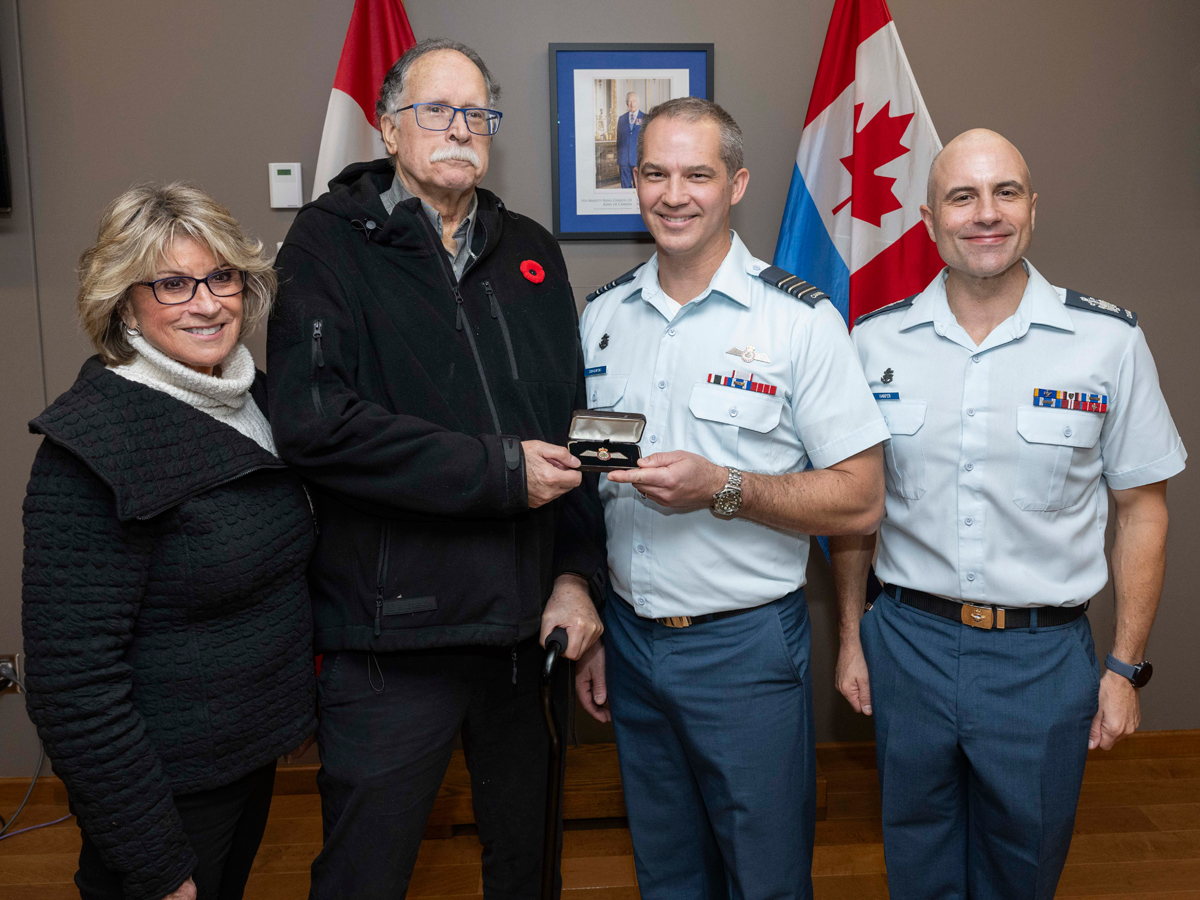 Mr. Jay Hammond recieves a set of wings created using the aluminum of his uncle's recovered Halifax bomber during a Commendation Presentation at 443 Maritime Helicopter Squadron on Oct. 18. Photo: Sailor 3rd Class Jordan Schilstra, MARPAC Imaging Services