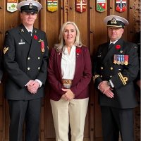 Master Sailor Jeffrey Harding and Sub-Lieutenant Jonathan Robinson stand with Rear-Admiral (Ret’d) Senator Rebecca Patterson in the Senate Chamber in Ottawa, Ontario.