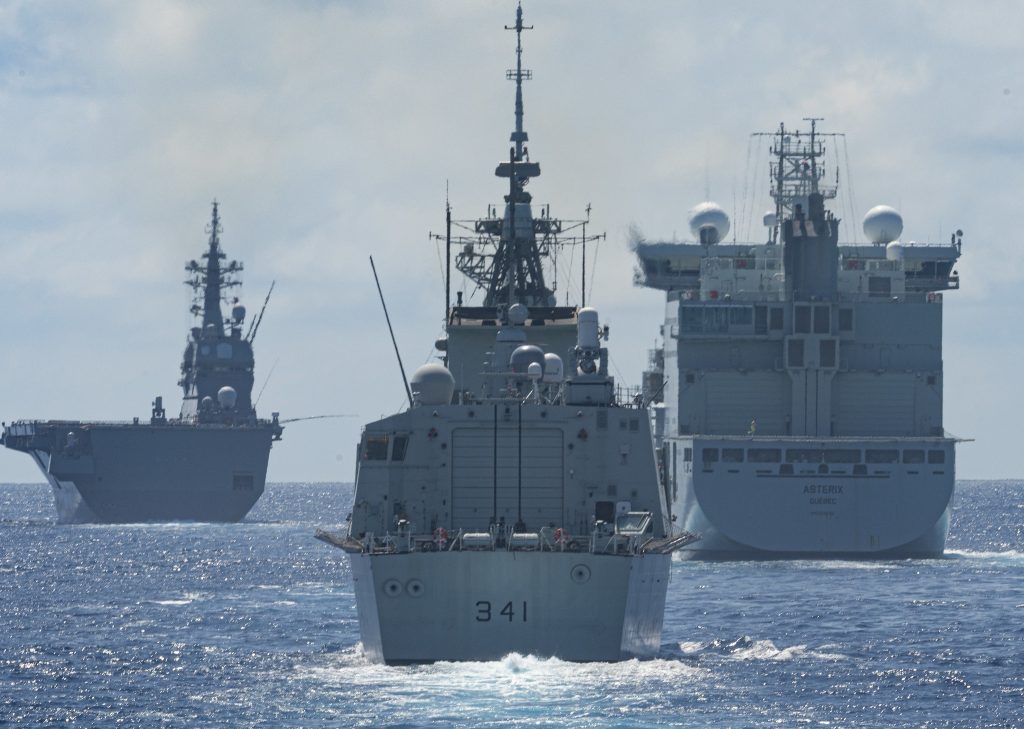 The Japanese Ship HYŪGA, His Majesty's Canadian Ship (HMCS) OTTAWA, and Motor Vessel (MV) ASTERIX sail together in the blue waters of the Indo-Pacific Ocean on 26 August 2023.