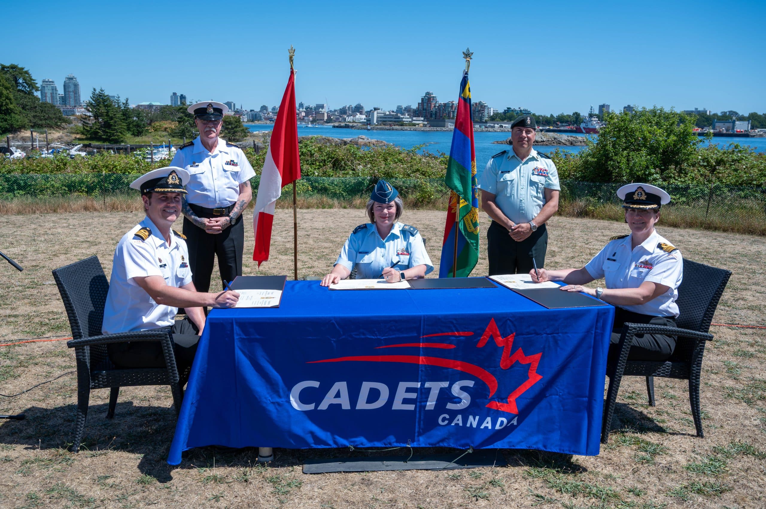 Cdr Benjamin Seaby, incoming CO, CPO1 David Bliss, Formation CWO Cadets and Junior Canadian Ranger Group, BGen Dominique Brais, Commander of Cadets and Junior Canadian Ranger Groupp, CWO David Shultz, RCSU (Pacific) CWO and Cdr Paula McHale, outgoing CO signing the Change of Command paperwork on July 7 2025