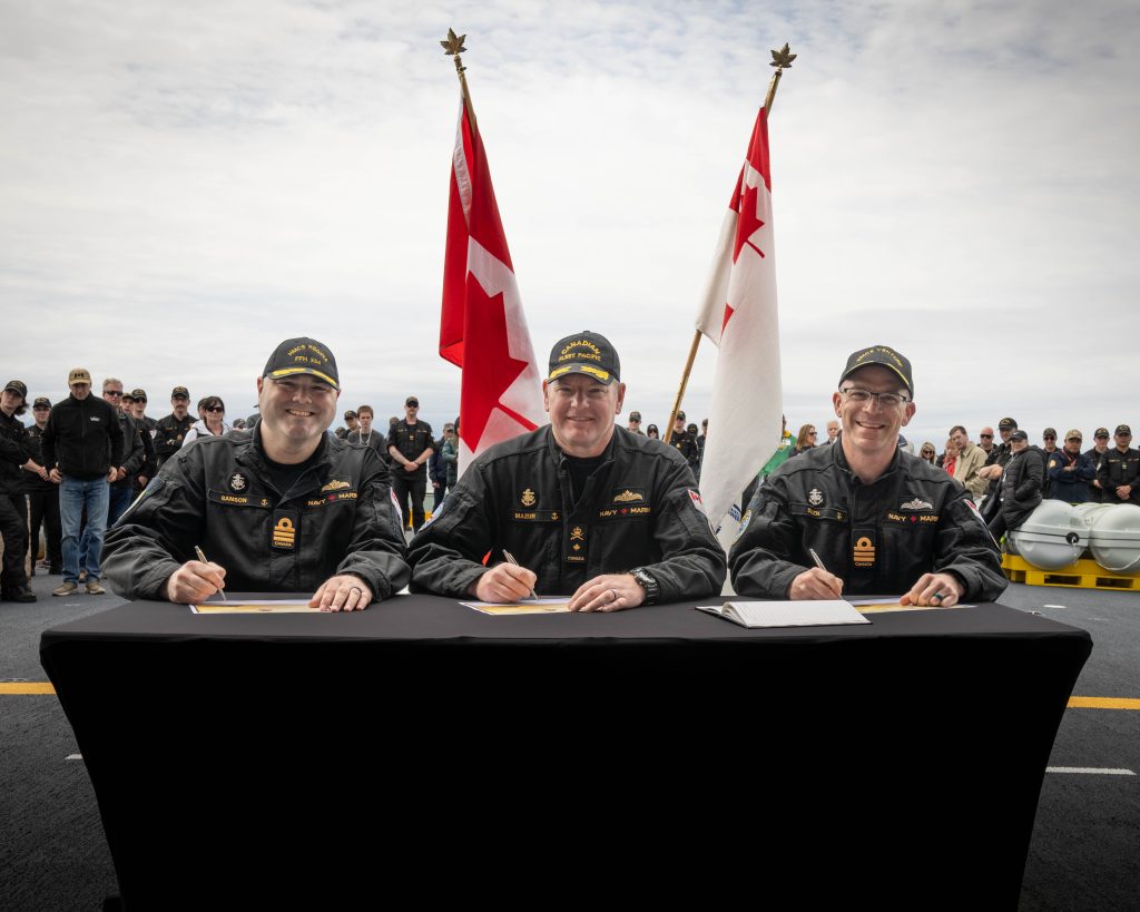 (Left to Right) Outgoing Captain (Navy) Jeremy Samson, Outgoing HMCS REGINA Commanding Officer, Commodore David Mazur, Combined Task Group 628.2 Commander and Incoming Commander Darren Sleen, Incoming HMCS REGINA Commanding Officer pose for a photo during the Change of Command ceremony aboard HMCS REGINA while at sea on 24 May 2025. Photo credit: Corporal Conor R.G. Munn, Canadian Armed Forces Imagery Technician