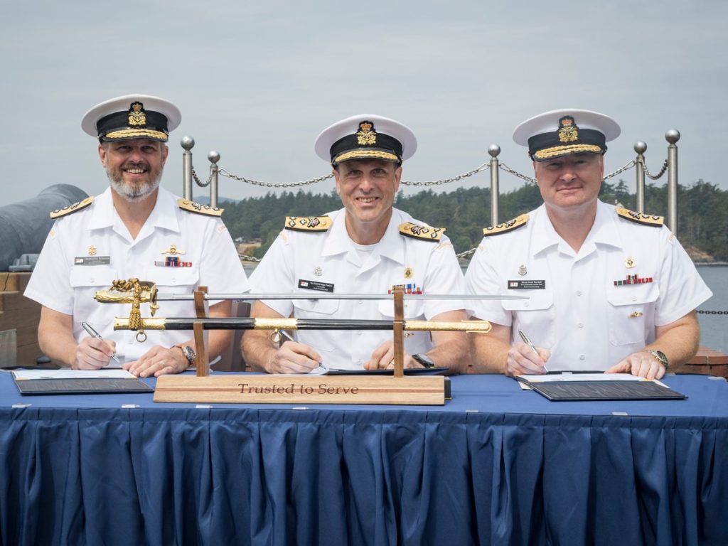 Rear-Admiral Christopher Robinson, Vice-Admiral Angus Topshee, and Rear-Admiral David Patchell sign the official change of command paperwork on Aug 5, 2025. Photo Credit: Master Sailor Bryan Underwood, MARPAC Imaging Services