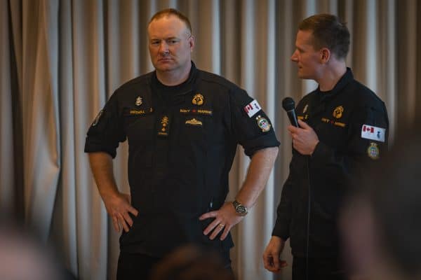 Rear-Admiral (RAdm) David Patchell, Commander of MARPAC/JTFP and Chief Petty Officer 1st Class (CPO1) Sorensen, Formation Chief, prepare to answer a question from a sailor on Nov 19, 2025. Photo: Master Sailor (MS) Bryan Underwood