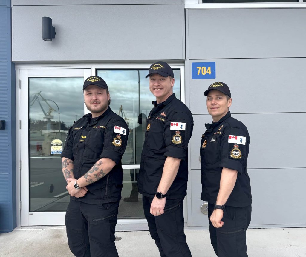 Sailor 1st Class (S1) Syrnick, Lieutenant(Navy) (Lt(Navy)) Gaudet, and Lt(Navy) Breese pose in front of the Patrol Craft Training Unit (PCTU) office building 704 while wearing their new unit crests. Photo: S1 Fiana Muchnik, PCTU