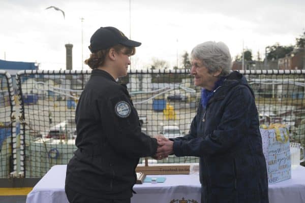 Mrs. Geraldine Hilton (right), the wife of the late Captain(Navy) Peter Hinton, warmly holds the hands of the 2025 Canadian Fleet Pacific
(CANFLTPAC) Sailor of the Year, Sailor 1st Class Andrée-Anne Dion-Tessier (left), during the presentation of the Capt(Navy) Peter Hinton Memorial Award for Leadership and Excellence in Service. Photo: Sailor 1st Class Jordan Schilstra, MARPAC Imaging