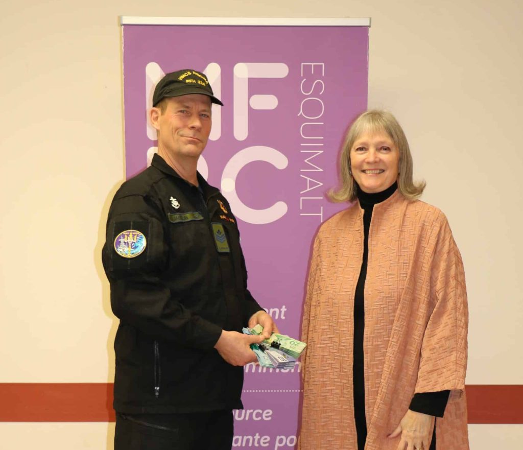 Sergeant Dan Jacklin, on left, donating over $2,000 in funds to the Esquimalt Military Family Resource Centre, represented by Executive
Director Jackie Carlé, on right. Photo supplied.