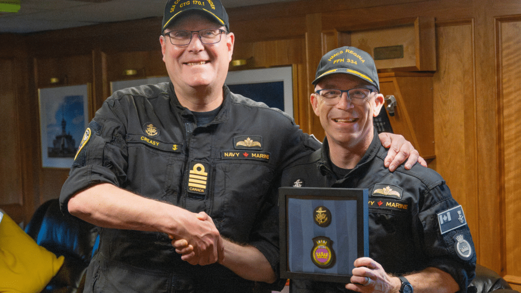 (Left to right) Captain(N) Landon Creasy shakes the hand of Commander Darren Sleen as he recieves the Gold Sea Service Insignia. Photo: Avr Rebecca Mainardi, MARPAC Imaging
