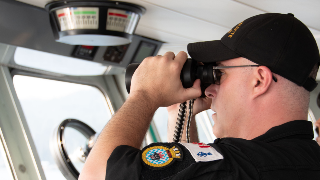 A sailor tracks the movement of a whale while aboard PCV Wolf 59. Photos: Lt(N) Krystal Fleury